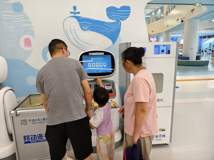 家长带孩子自主借书。周晓思摄